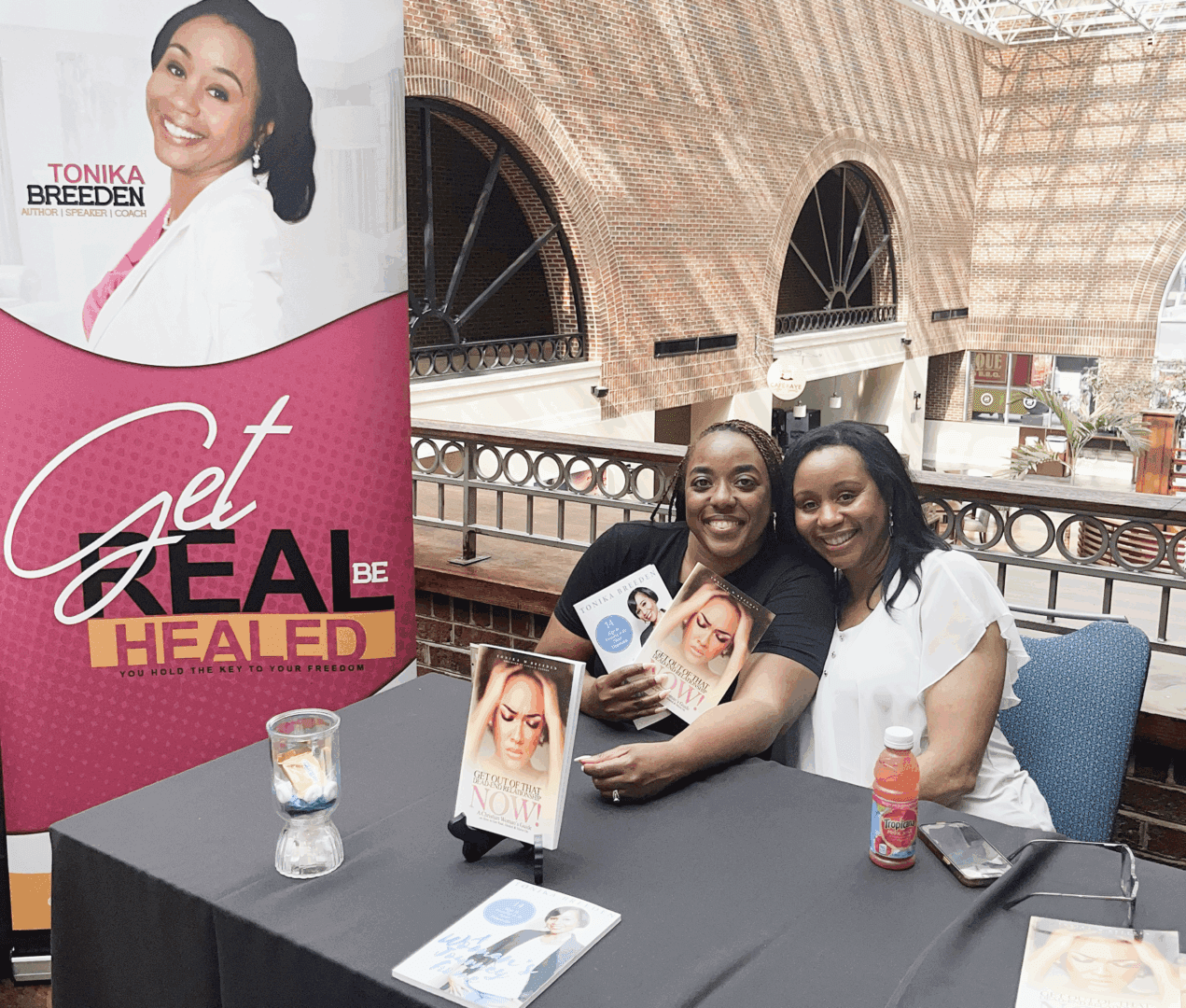 Authors signing books at event table